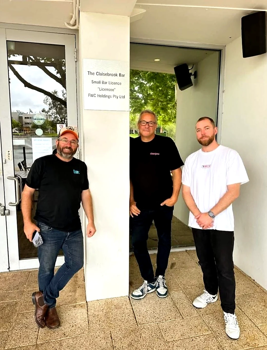 Three members of the Danjoo team and partners standing together in the entrance of The Claisebrook Bar in East Perth.